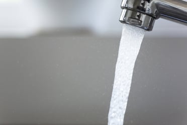 Water running from a tap into a kitchen sink-1