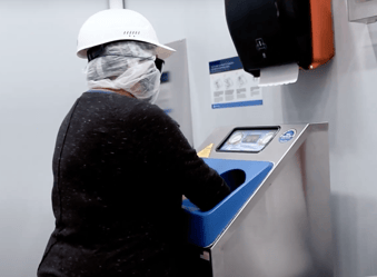 Person using a CleanTech® automated handwashing station