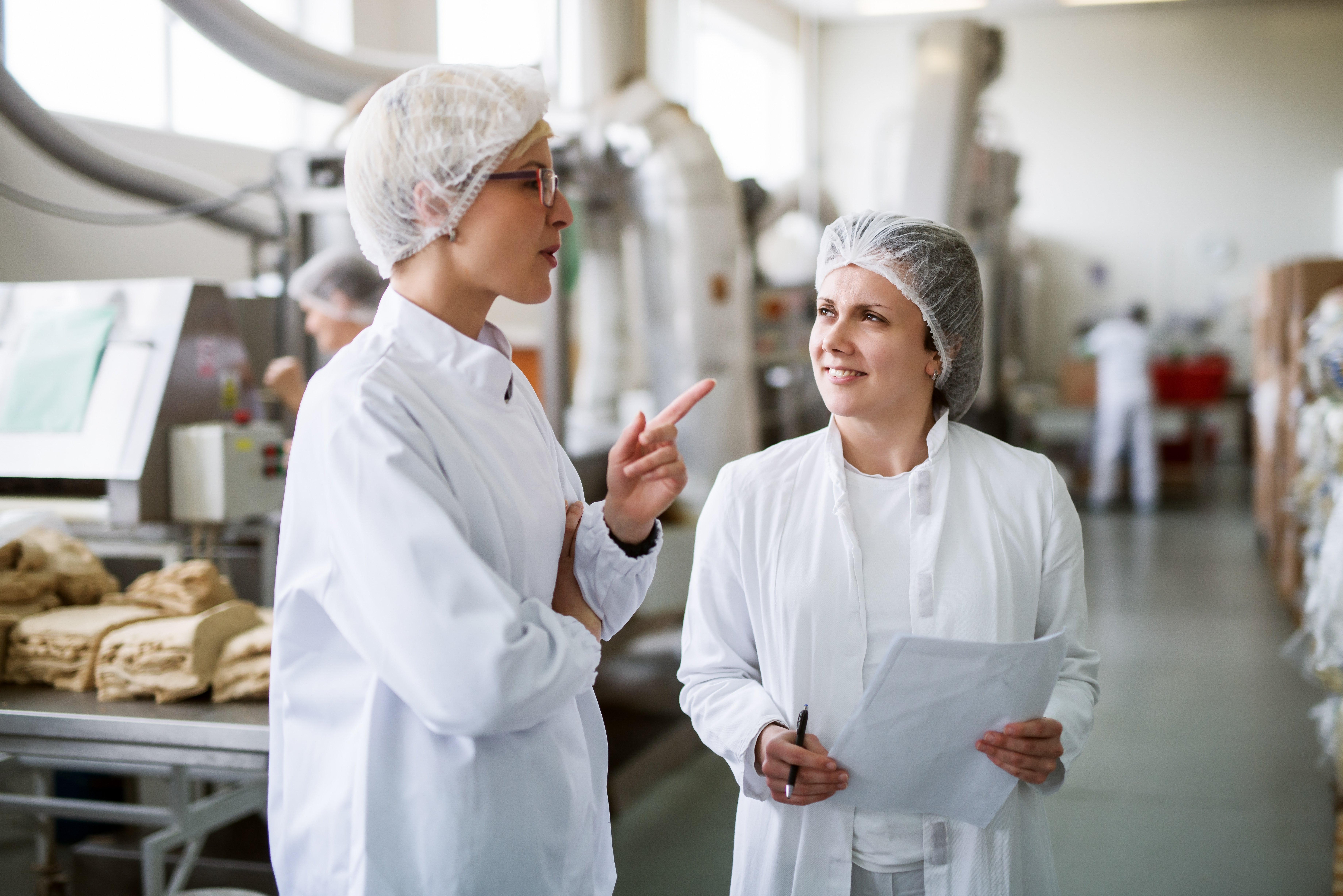 Two Food Processing Employees Discussing Food Safety Culture