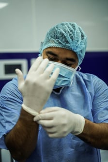 person putting on gloves